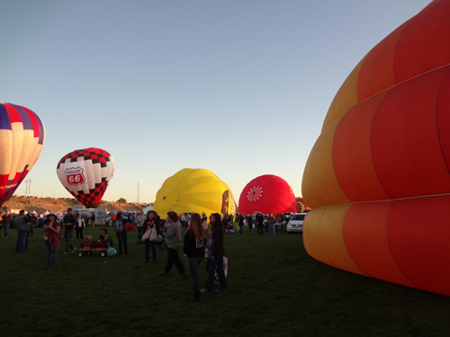 lots of hot air balloons - some glowing