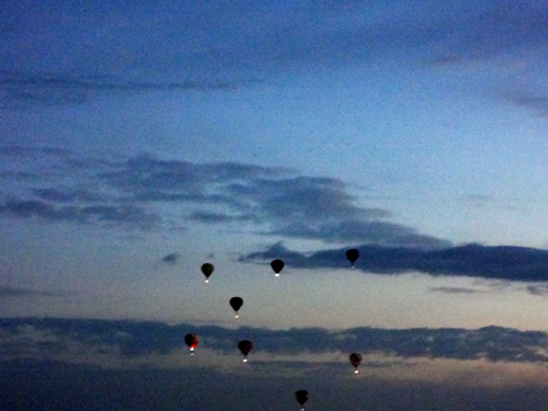 a few hot air balloons in early morning flight