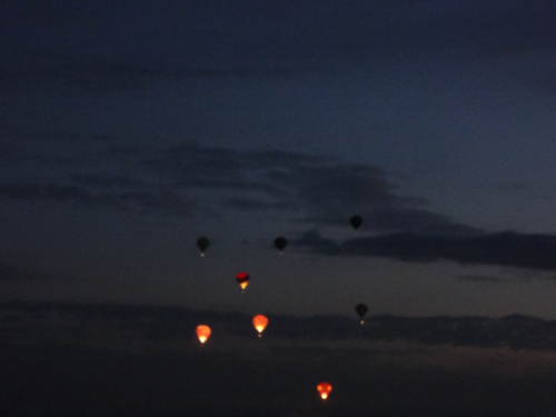 a few hot air balloons in early morning flight