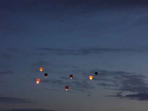 a few hot air balloons in early morning flight