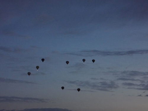 a few hot air balloons in early morning flight