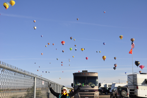 lots of hot air balloons over an RV