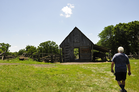 Lee Duquette approaching the 1850 Pioneer Farm log cabin
