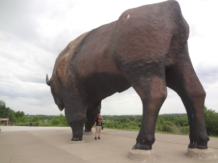 Karen Duquette standing under the World's Largest Buffalo statue