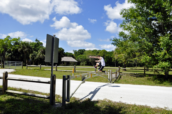 Josh jumping over a fence