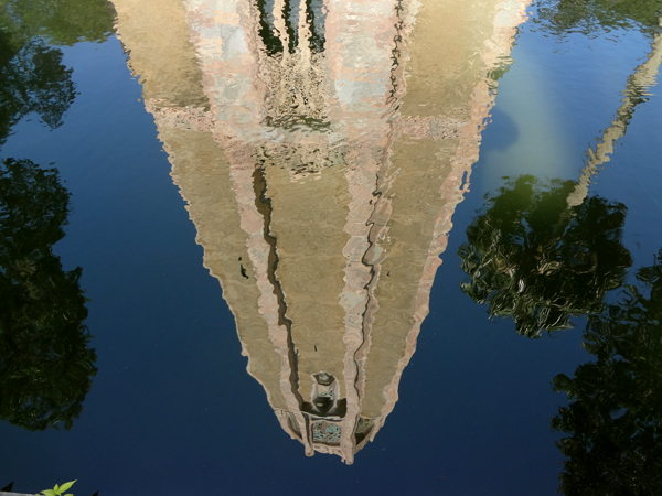 the tower's reflection in the moat that surrounds the tower.