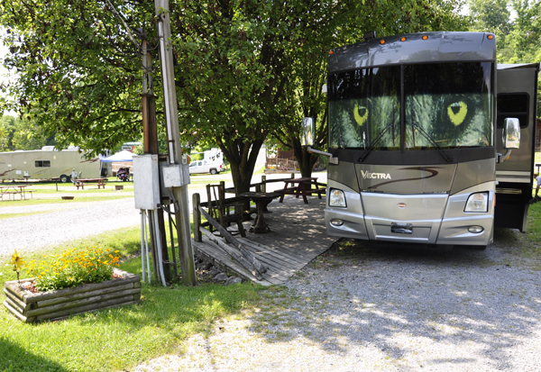 The motorhome of The Two RV Gypsies at the cowgirl sign for the ladies room at the Bristol / Kingsport KOA 