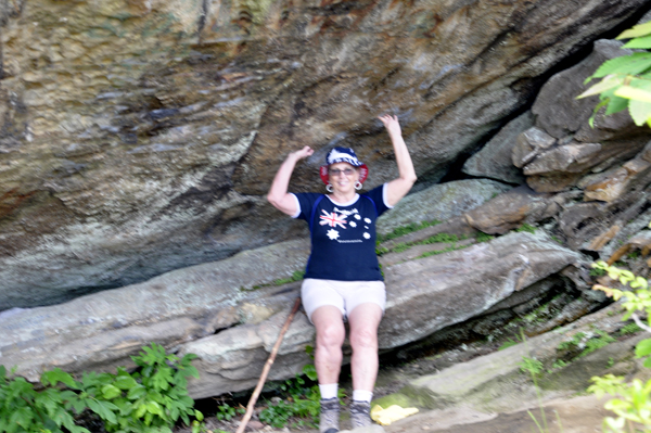 Karen Duquette sitting on a ledge under one of the big boulders at Chained Rock.