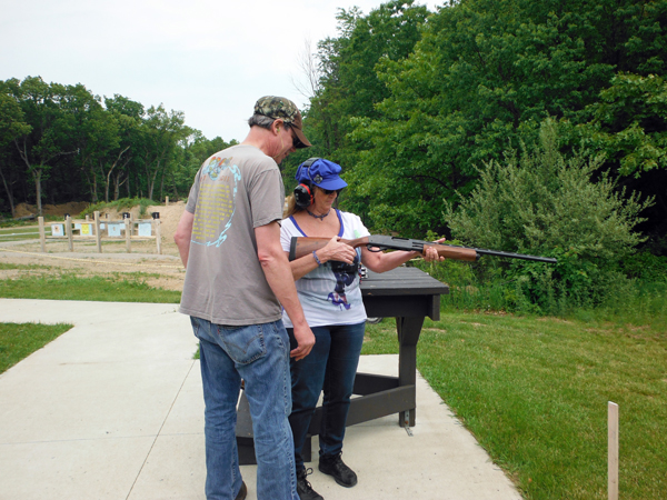 Bruce giving Karen lessons on how to use the rifle.