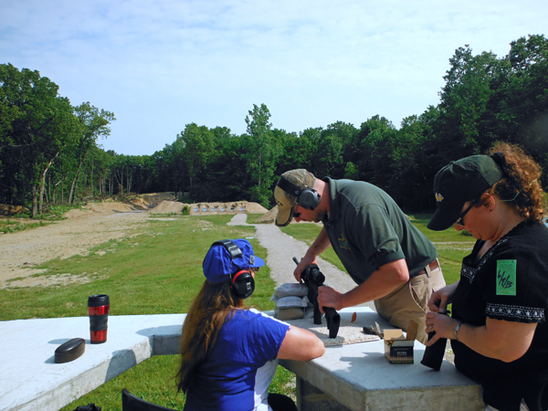 Karen Duquette getting instructions on gun and target range procedures