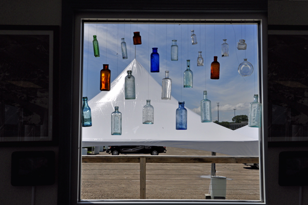 Bottles hanging in the window inside The Great Lakes Maritime Center