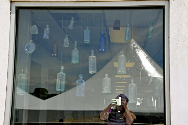 Bottles hanging in the window inside The Great Lakes Maritime Center