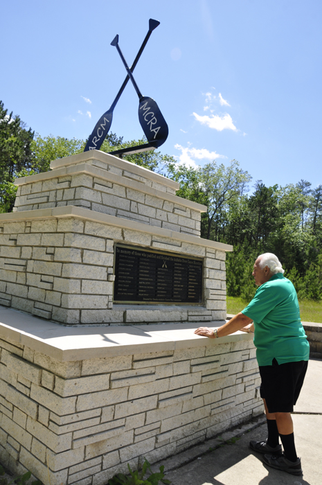 Lee Duquette reading the plaque at The Canoer's Monument