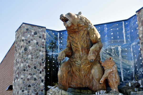 bear and cub on top of a store