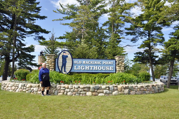 Lee Duquette by the Old Mackinac Point Lighthouse sign