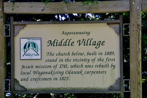 sign on the tunnel of trees