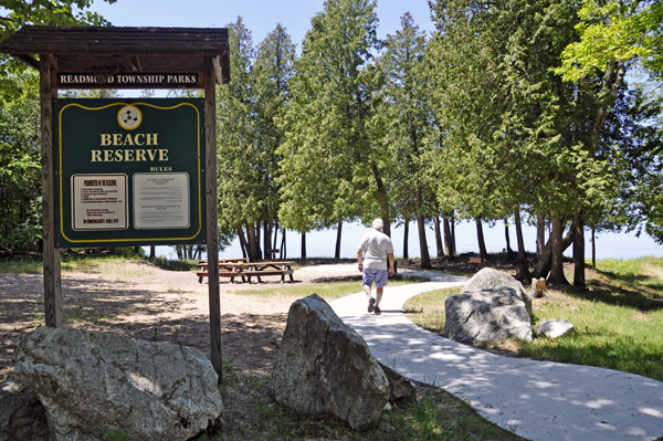 Lee Duquette and the Good Hart Beach Reserve sign