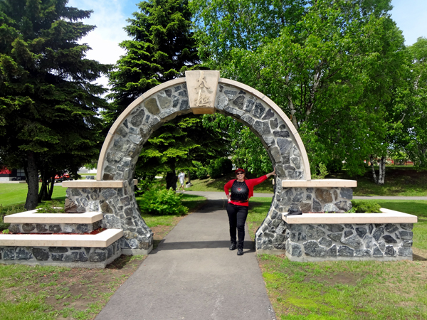 Karen Duquette stands under an arch