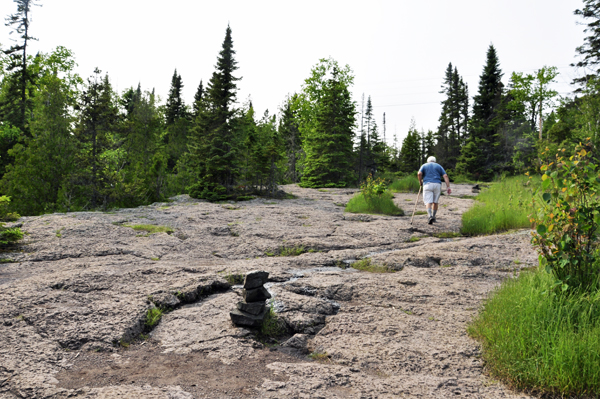 Lee Duquette walking on top of an old waterfall that is now stone