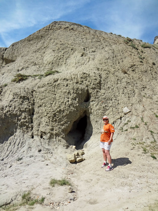 Karen Duquette by a cave in Castle Butte