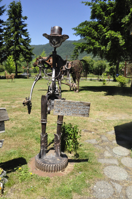 sculpture with sign asking for donations