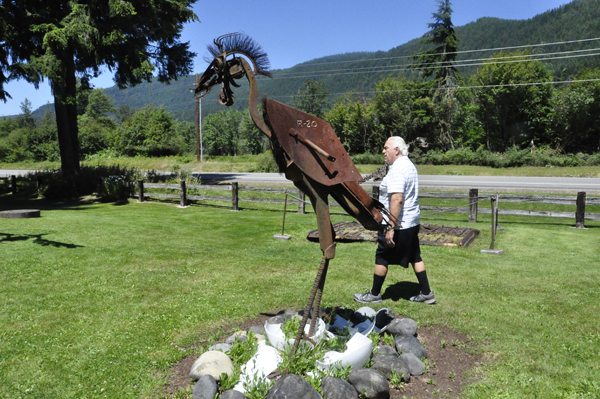 Lee Duquette by a giant bird sculpture with hatched eggs