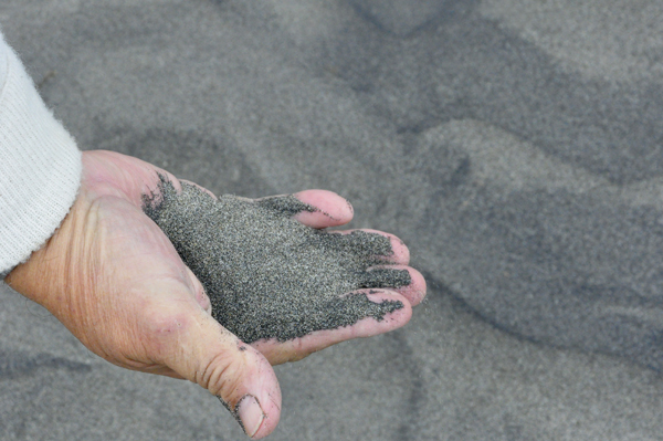 Lee notices that the sand is soft and black.