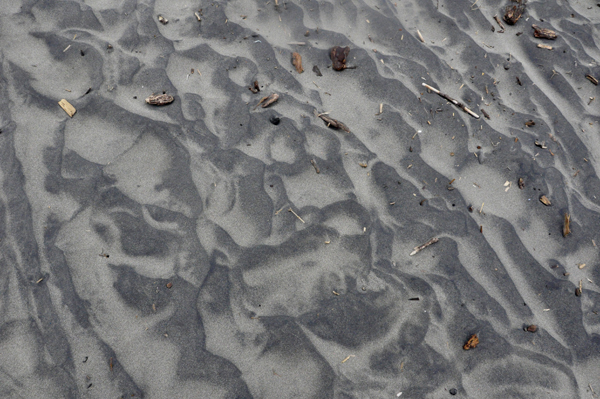 Karen likes the tracks and designs in the dark colored sand