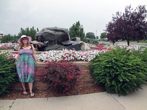 Karen Duquette at the rock fountain and flowers near Capitol Lake