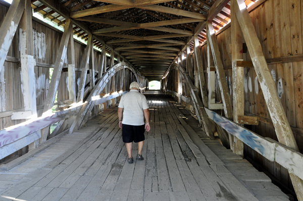 Lee Duquette walking through The West Union Covered Bridge