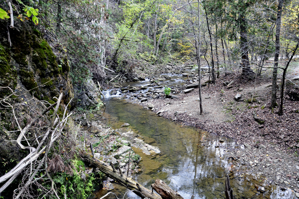 View of the river stream from the bridge to the cave.