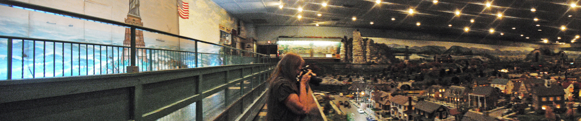 Karen Duquette and a panorama of the miniature village