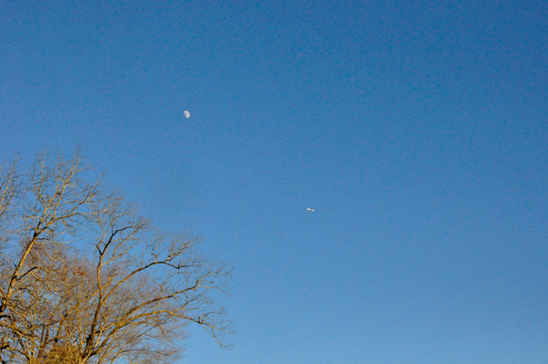 The moon and an airplane passing by