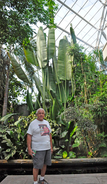 Lee Duquette in front of a a tall Traveler's Tree