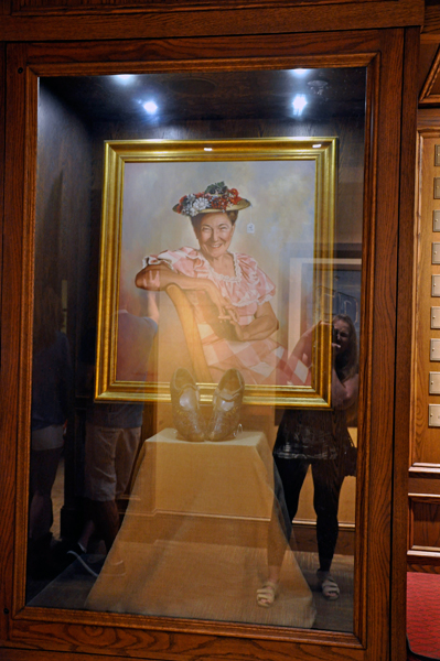 Karen Duquette takes a photo of a display for Minnie Pearl