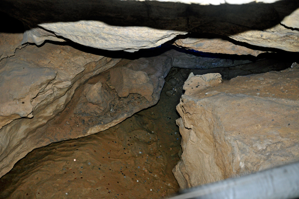 coins in water in the cave