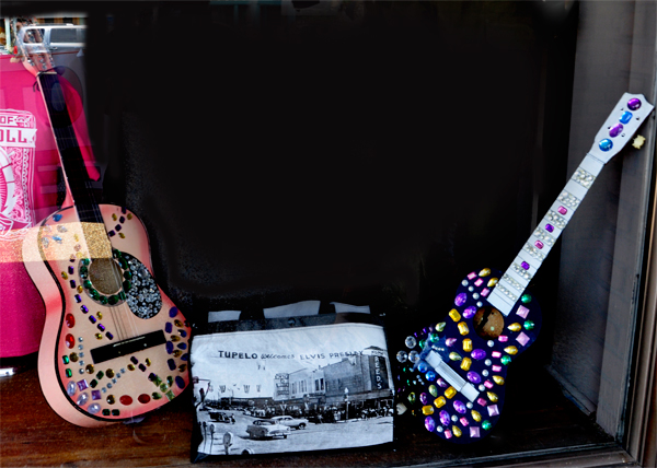 two beaded guitars in a store window