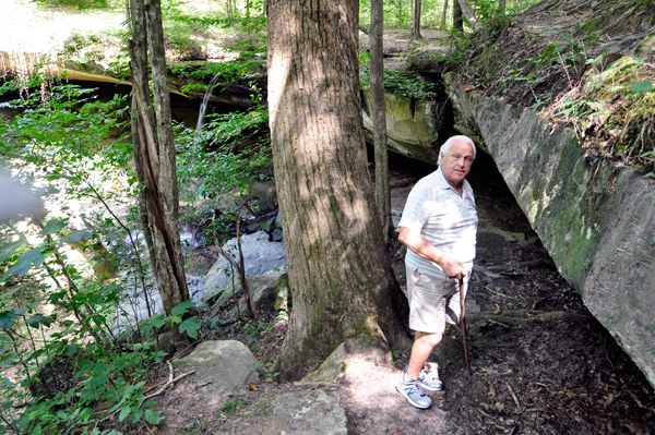 Lee Duquette determins that he has to bend under the boulder