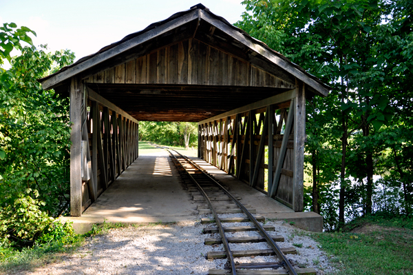 covered bridge and train tracks