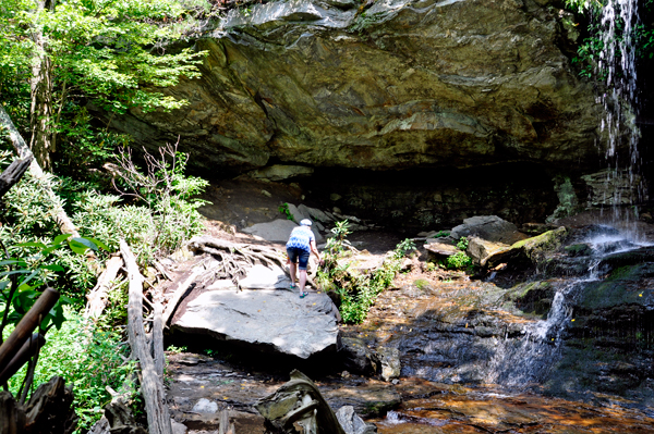 Karen climbs up and up over the boulder