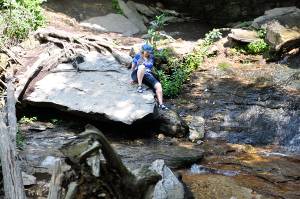 Karen Duquette slides down the boulder