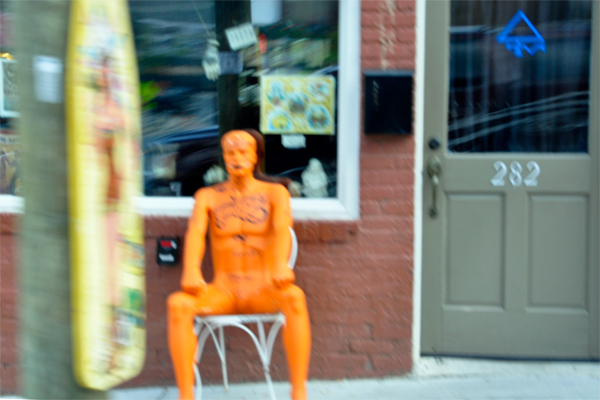 A big, naked, tattooed, orange man