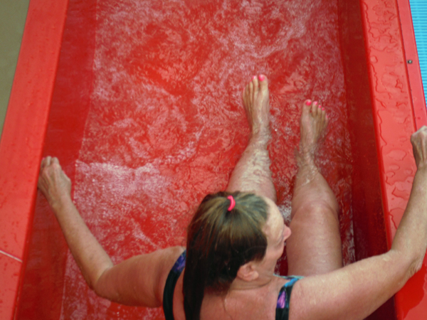 Karen exiting the orange waterslide.