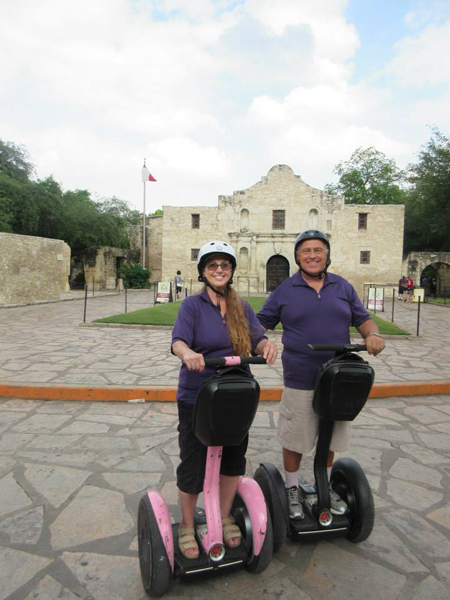 The two RV Gypsies in front of The Alamo on Segways