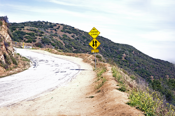 curvy road and steep cliff down