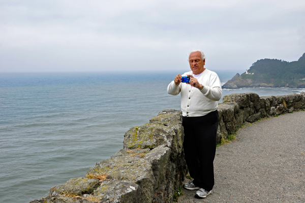 Lee Duquette and a Heceta Lighthouse in the background