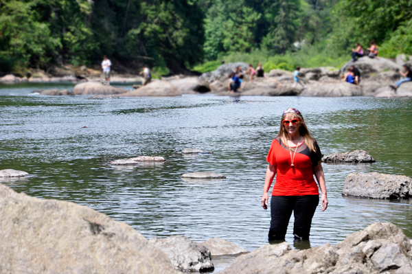 Karen decides to walk a bit in the river.