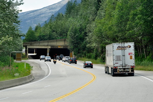 cars and trucks entering a snow shed