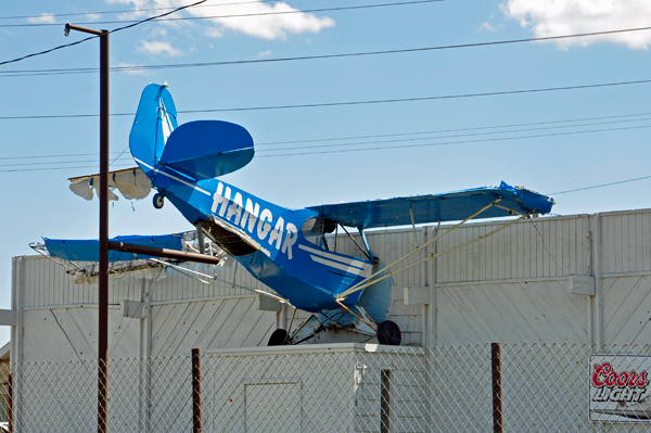 a small airplane poking out of a tavern