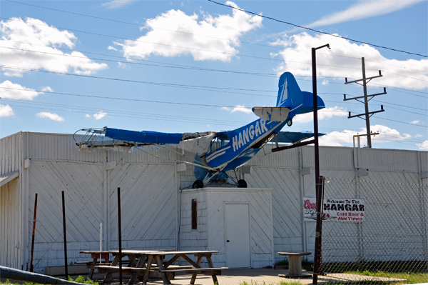 a small airplane poking out of a tavern